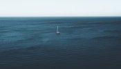 single boat in the middle of an ocean