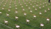 Chairs spaced out in a field