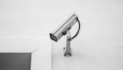 a security camera on a white wall