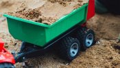 child playing with sand cart