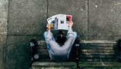 birds eye view of man reading paper