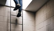 Man walking up a ladder