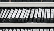 a shelf of file documents