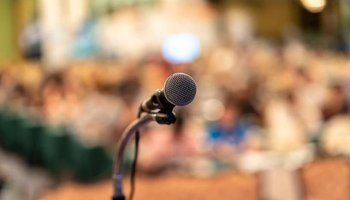 stock-photo-microphone-abstract-blurred-photo-conference